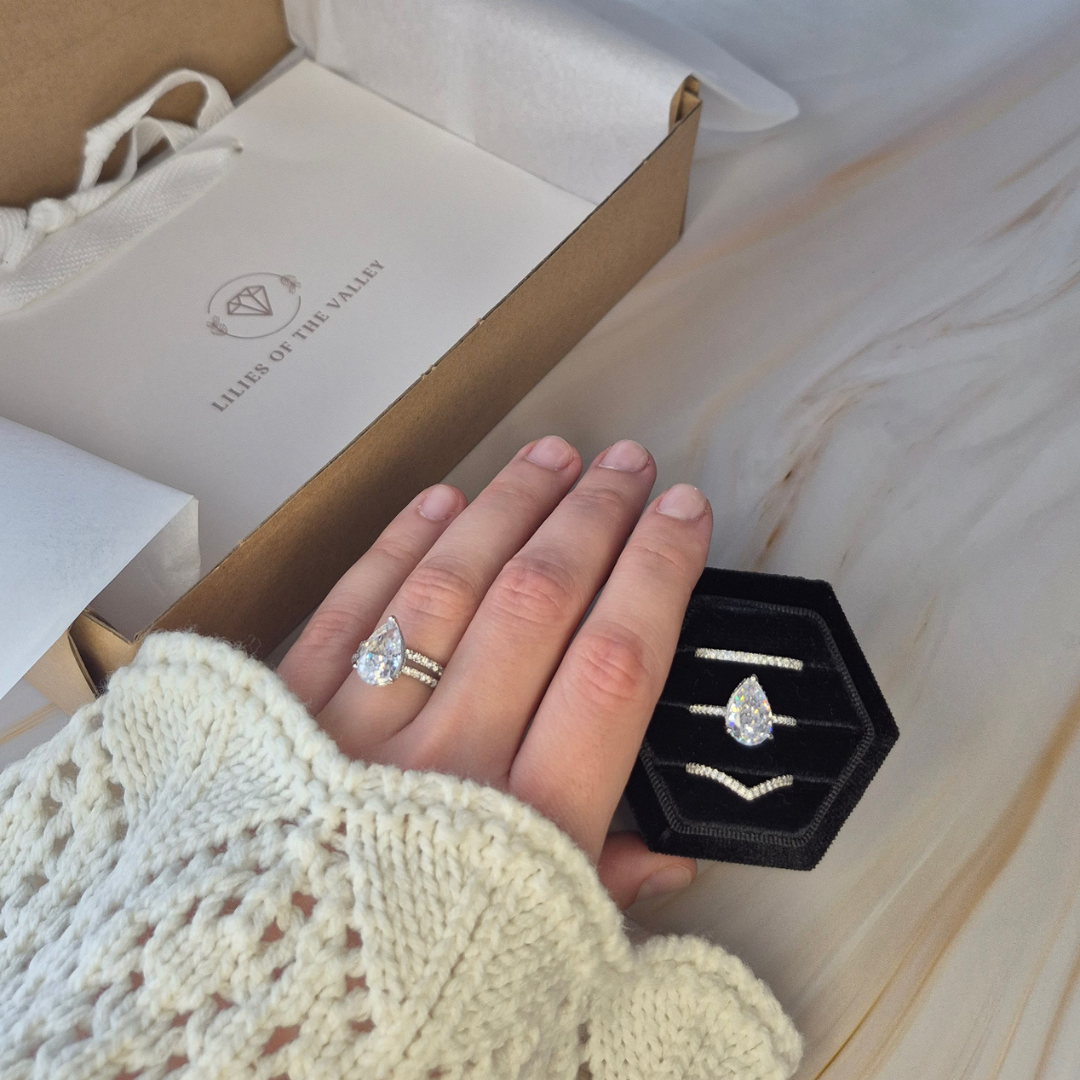 Silver V-shaped eternity ring UK stacked with eternity and pear cut pavé rings — Petal Crest CZ stacking rings in 925 sterling silver — Lilies of the Valley