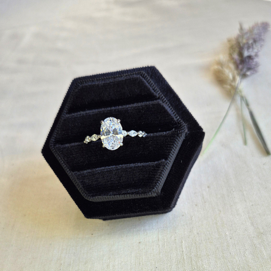 The Lily Crown Ring features a bold oval cut cubic zirconia centre stone, surrounded by a delicate band of alternating marquise and round CZ stones.