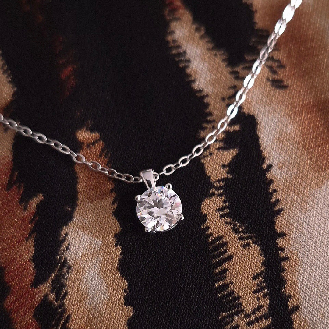 Close up of Dewdrop Glow moissanite pendant catching the light, showing brilliant sparkle and shine, sterling silver, Lilies of the Valley UK