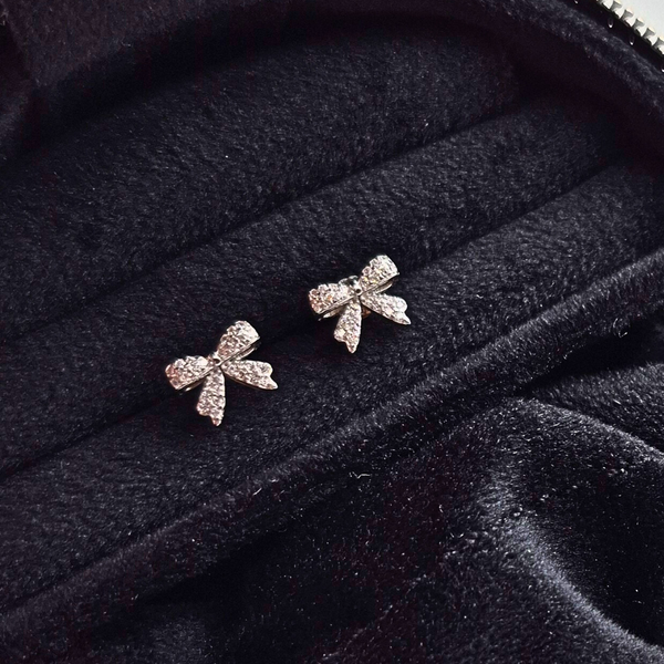 Silver bow stud earrings UK close up — Diamond Blossom Bow CZ studs in 925 sterling silver — Lilies of the Valley
